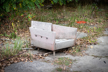 An old abandoned chair on the street of the city of Pripyat, Chernobyl Exclusion Zone, Ukraine