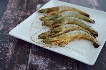Fresh raw prawns on white plate