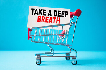 a business card with text TAKE A DEEP BREATH in a shopping cart. business and finance