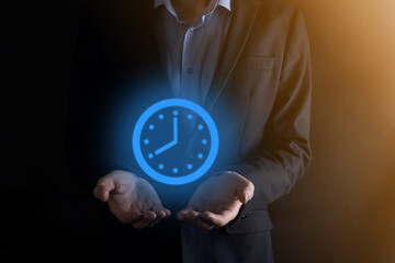 Businessman hand holds the icon of hours clock with arrow. Rapid execution of the work.Business...
