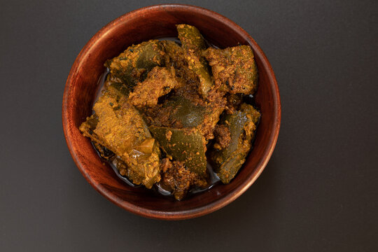 Mango pickle or Traditional spicy Indian mango pickle, selective focus top view isolated on black