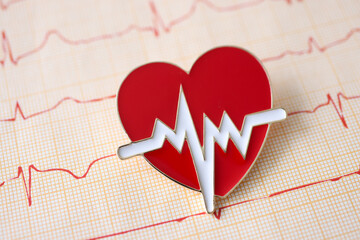 Result of electrocardiogram with icon lies on table