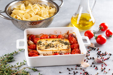 Feta cheese pasta sauce recipe step. Tomatoes drizzled with olive oil in a baking dish with a feta...