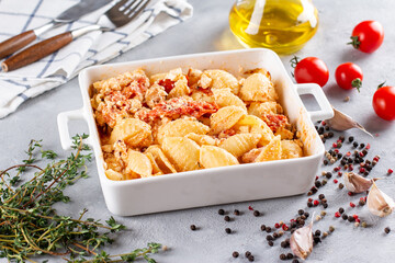 Cooking baked feta pasta. Raw ingredients before cooking: pasta, feta cheese, olive oil and cherry tomatoes with herbs and garlic. New, popular dish.