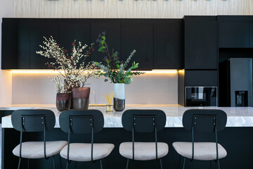 Bright modern kitchen with leather bar stools.