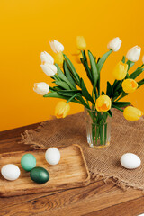 spring holiday easter decoration painted eggs yellow background