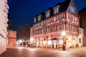 Fototapeta na wymiar Half timbered house at night and street lights near Eiserner Steg in Frankfurt am Main, Germany