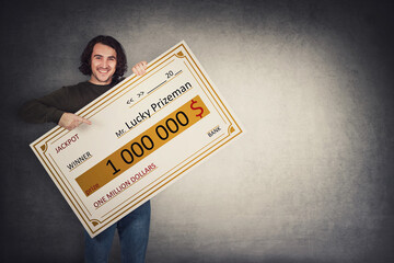 Excited man holding a lottery winner bank check. Happy guy jackpot winning one million dollars...