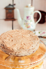 Delicious round cake with white caramel and coffee buttercream. Homemade sweets for birthday