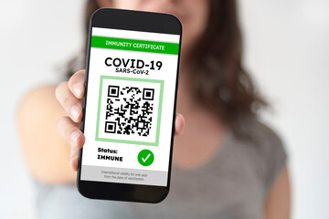 Unrecognizable woman showing on her smartphone a certificate of Covid immunity