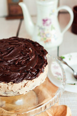 Delicious round cake with white buttercream topped with chocolate frosting, coating. Holiday and festive food concept