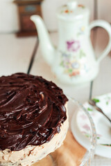 Delicious round cake with white buttercream topped with chocolate frosting, coating. Holiday and festive food concept