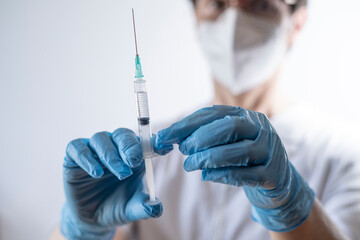 nurse preparing syringe for vaccination
