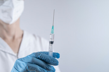 nurse preparing syringe for vaccination