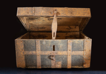 An old chest made of wood upholstered with iron