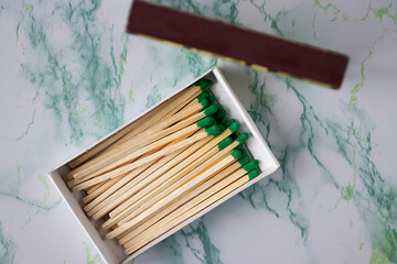 Matches in a box on a marble background.