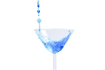 Cocktail with blue liquid in glass. Glass with blue water pouring with liquid with splashes and drops. Martini glass filling with alcohol with splashes on white background. Refreshing drink concept.