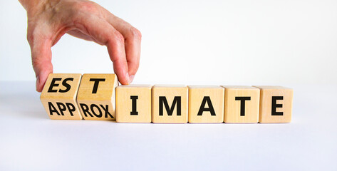 Estimate or approximate symbol. Businessman turns wooden cubes and changes the word 'approximate' to 'estimate'. Beautiful white background, copy space. Business, estimate or approximate concept.