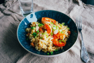 Homemade shrimp paella served in blue plate