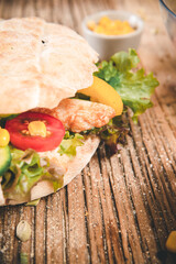 Delicious sandwich on wooden table. Tasty fast food