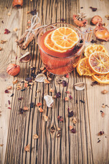 Glass cup of fruit tea with dry orange and cinnamon