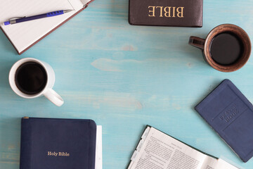 Bibles, prayer book, journal and two cups of coffee in flat lay with copy space