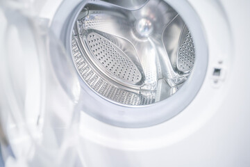 open door of an empty washing machine close up