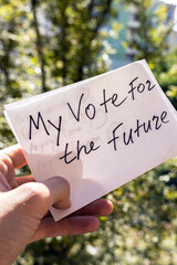 hand holding a "My vote for the future" poster. Democracy Freedom Concept.