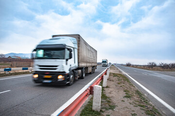 Obraz na płótnie Canvas trucks on asphalt road