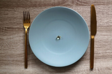 Vitamin D pill on a plate. Flat lay.