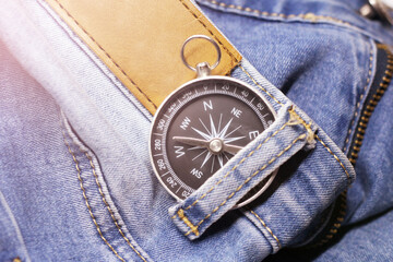 Retro compass on blue jeans