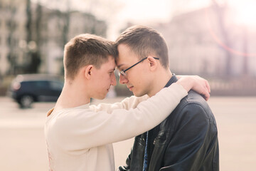 Young gay couple smiling happy and hugging at the city.