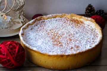 Round sweet pie made of cottage cheese and pumpkin, sprinkled on top with powdered sugar