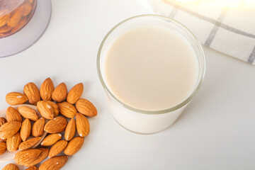 Fototapeta na wymiar Step by step recipe. Cooking nuts vegetable milk. Step 3 cooked almonds milk in glass. Homemade food concept. Plant based organic veggie milk, lactose free