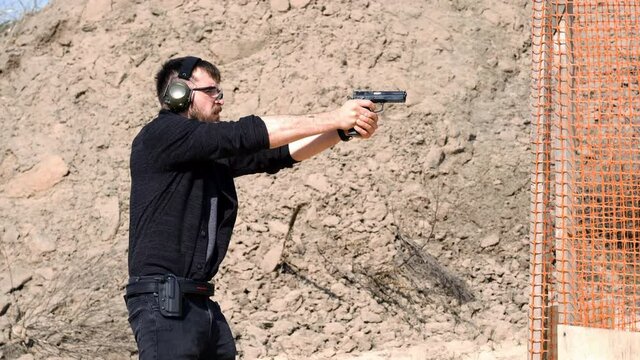 Man fires automatic handgun pistol during training in practical shooting. A man practicing shooter a pistol