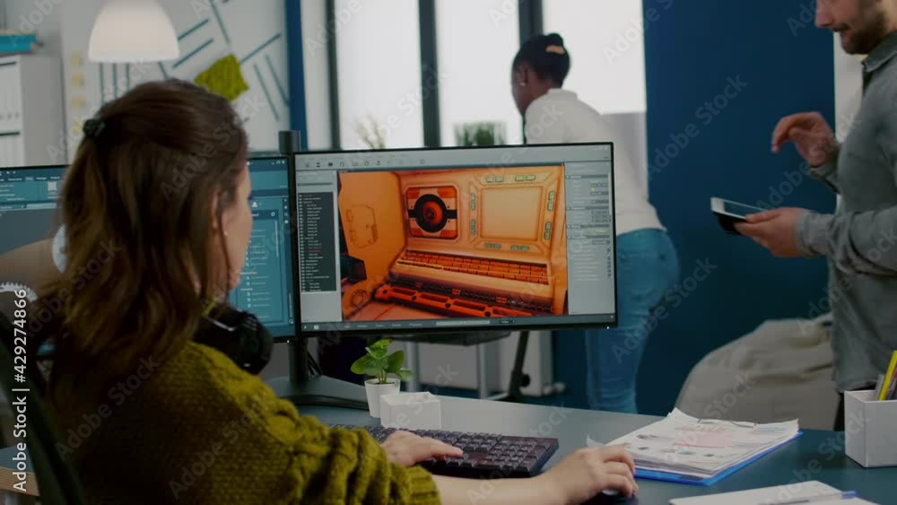 Poster diverse women game sofware developers testing new game sitting in startup creative agency company us
