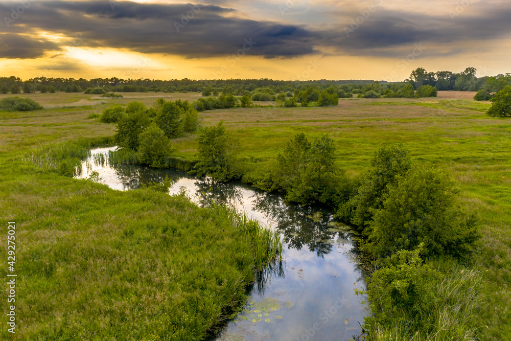 Canvas Prints Aerial view of green grassland river valley