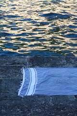 Blue towel on a beach at sunset. Selective focus.