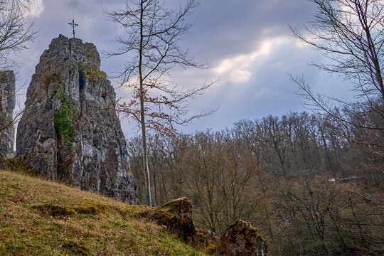 Lookout rock with real summit cross in the Bilstein valley near Warstein in Germany
