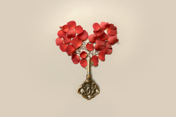 Valentine's card. Rose petals in the shape of a heart. And the key to the heart
