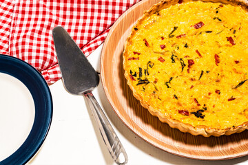 Homemade corn cake or quiche with onion, red bell pepper and chives. Healthy and natural food.