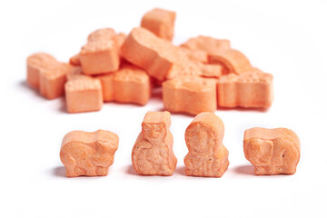 Orange animal shape vitamins for kids isolated on a white background. Assorted animal shaped multivitamins for kids. Chewable pills