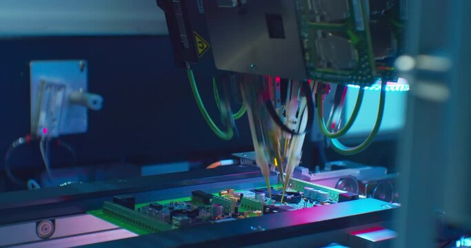 Modern industrial electronics manufacturing equipment makes a complex printed circuit board.High-tech production close-up.