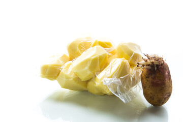 peeled potatoes closed in a vacuum bag and old sprouted potatoes