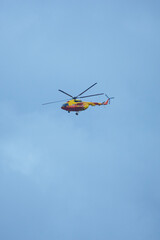Naklejka na ściany i meble Helicopter Flight yellow windship in the blue sky