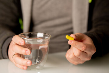 Male hand with vitamin pill