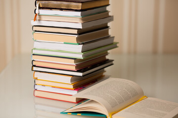 Pile of books on a desk at home