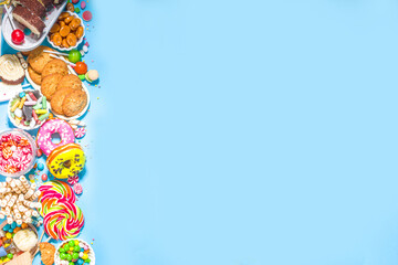 Selection of colorful sweets. Set of various candies, chocolates, donuts, cookies, lollipops, ice cream top view on trendy bright blue sunny background