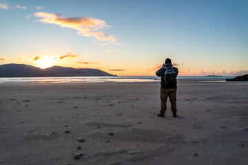 Man standing at Kiltoorish bay beach between Ardara and Portnoo in Donegal - Ireland.