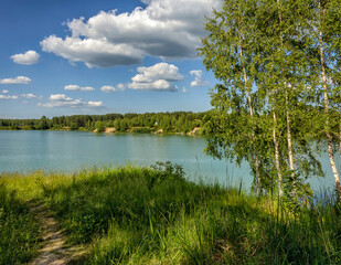 Summer vacation on the banks of an old quarry with turquoise water.
